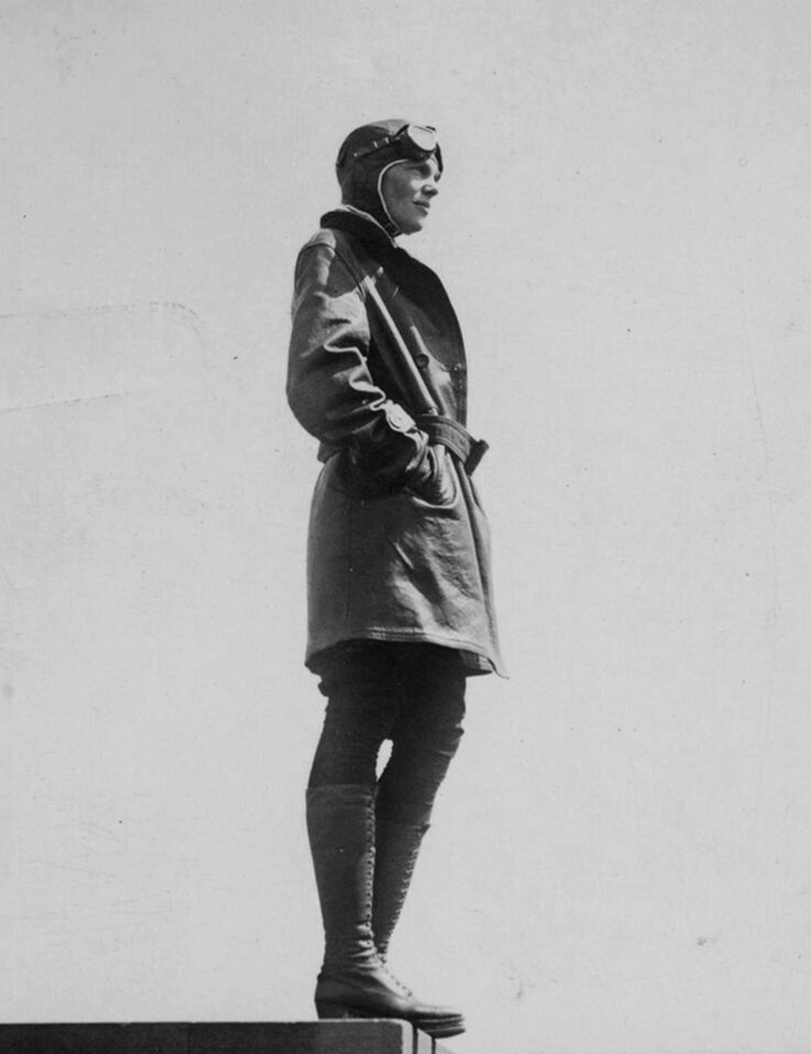 Person in glider clothes standing on platform